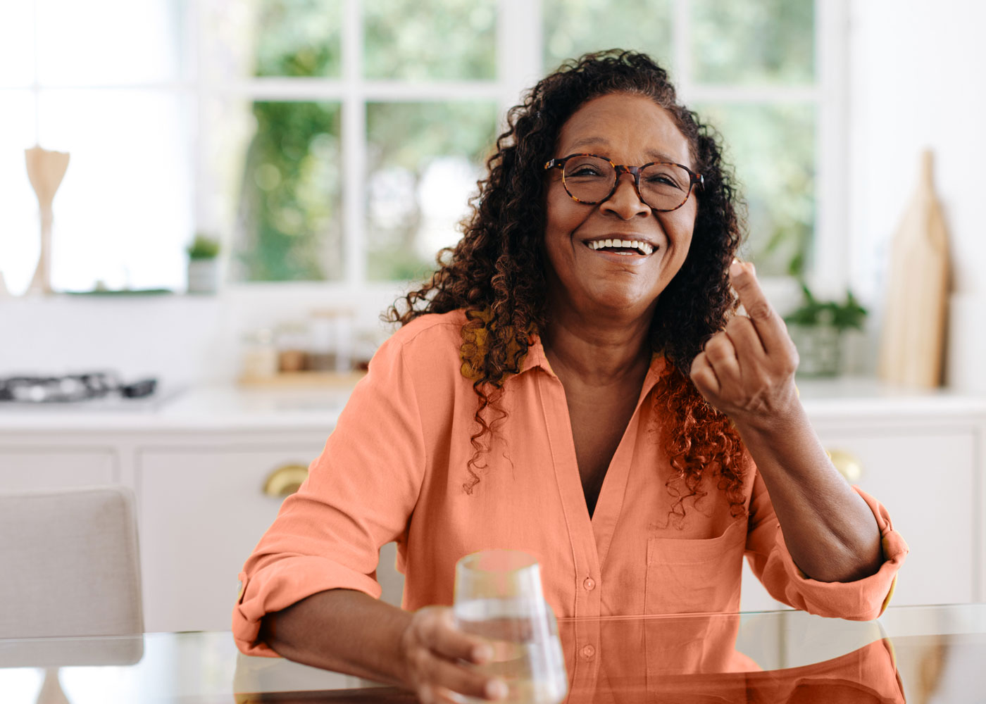 Woman holding a pill.