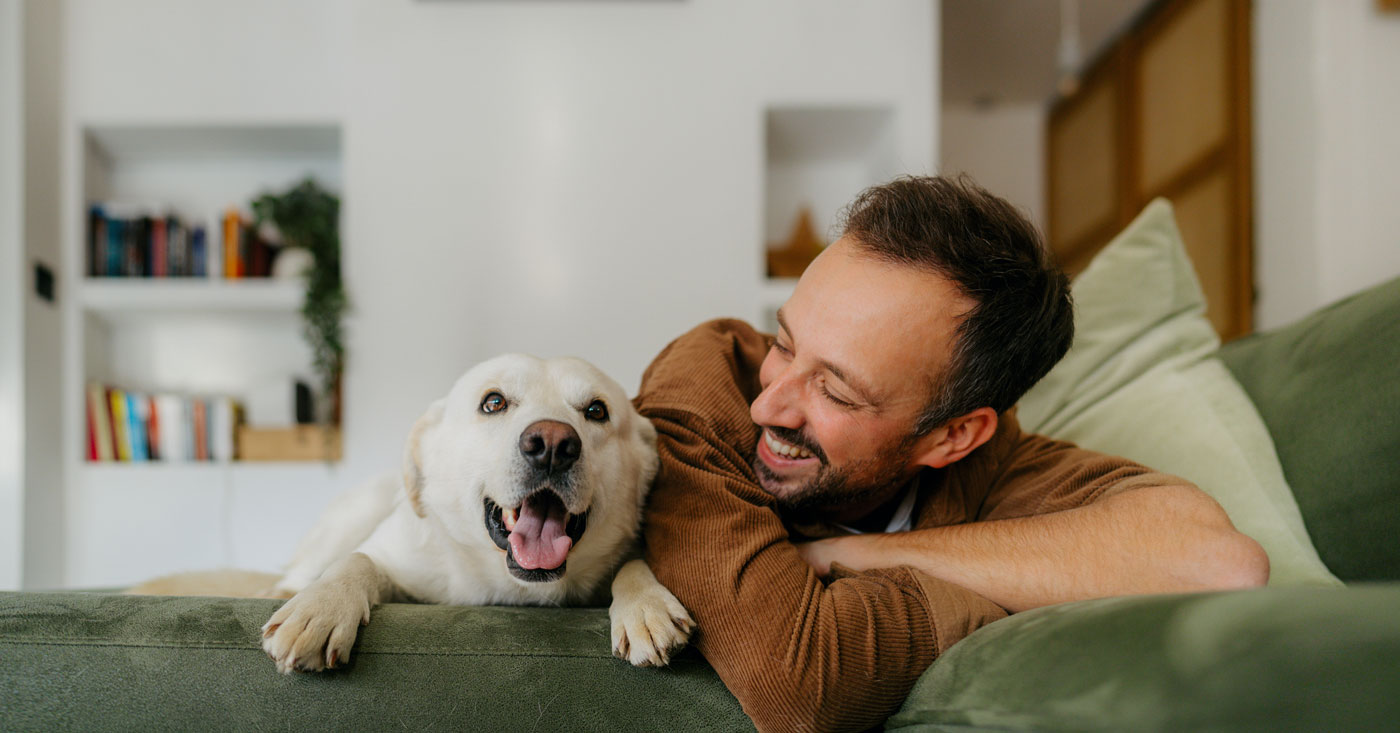 Man on couch with dog.