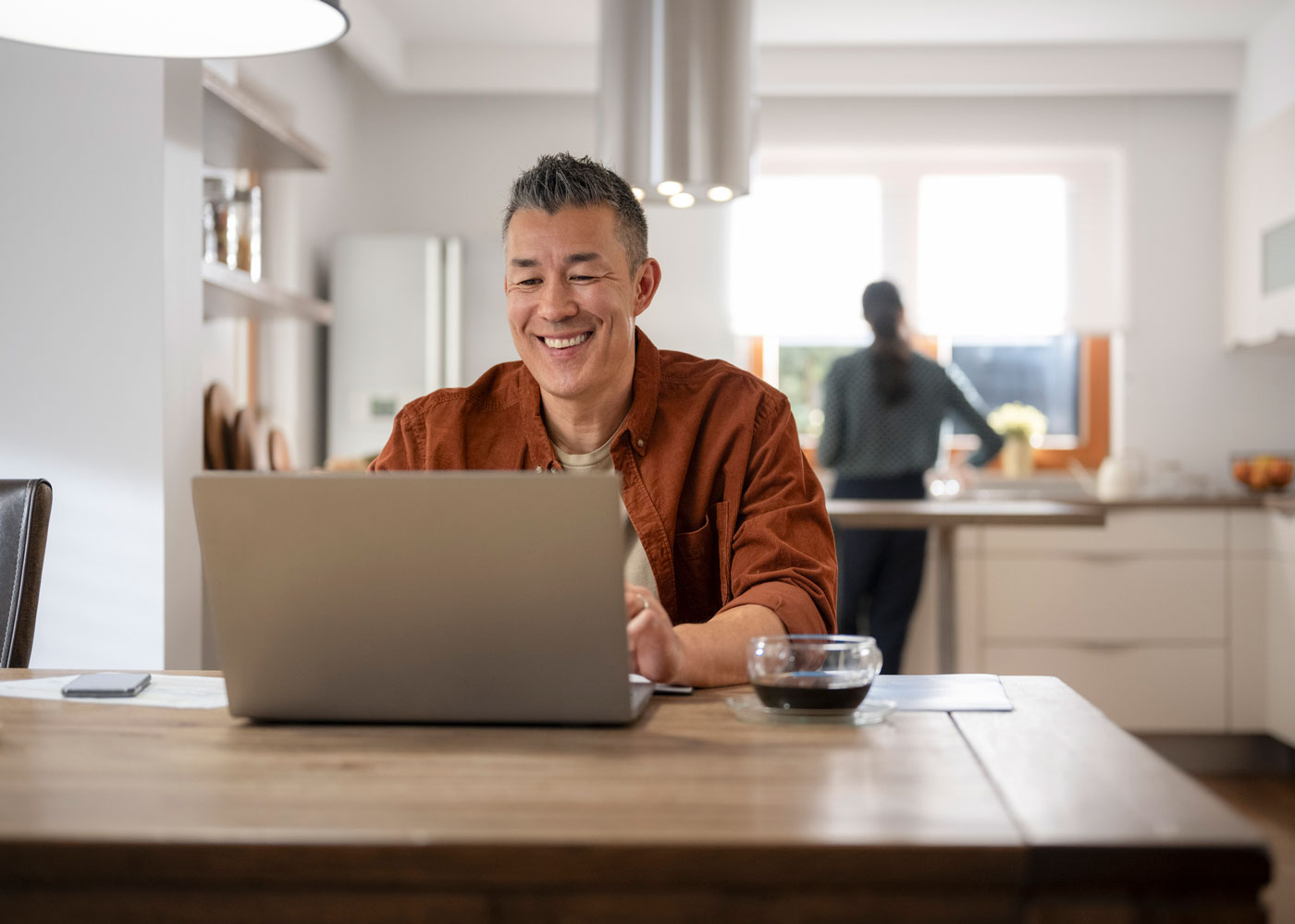 Man ordering prescription on laptop.