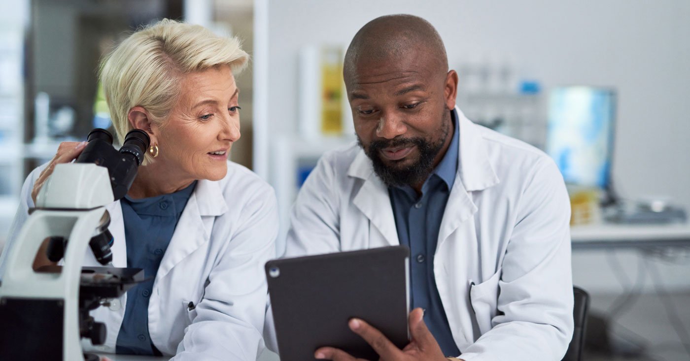 Two pharmacists looking at a tablet.