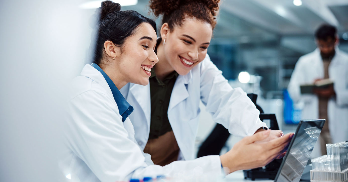 Two women in lab at computer.