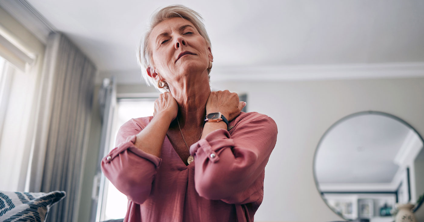 Woman experiencing neck pain.