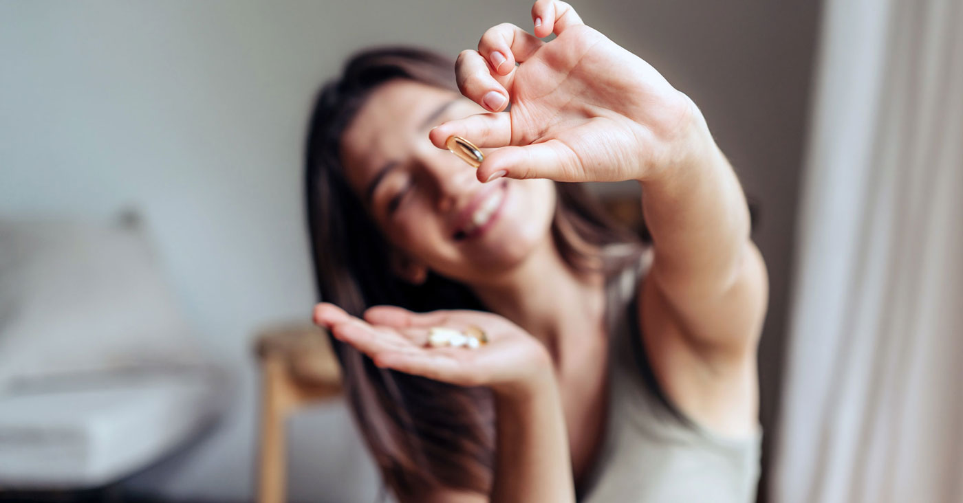 Woman holding vitamins.