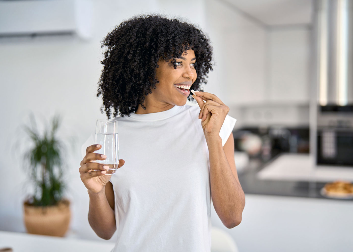 Woman taking a pill.