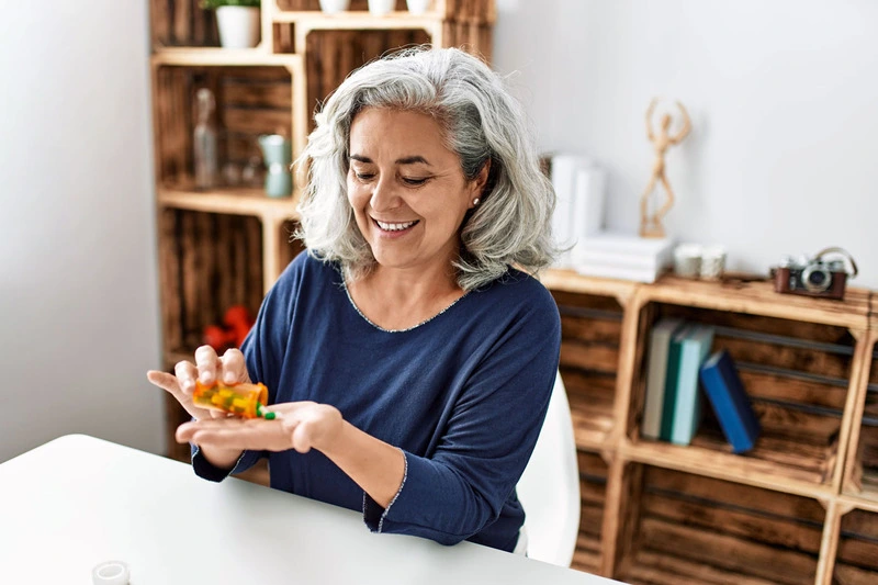 Older Woman Taking Medication Tablets